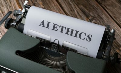 Retro typewriter with 'AI Ethics' on paper, conveying technology themes.