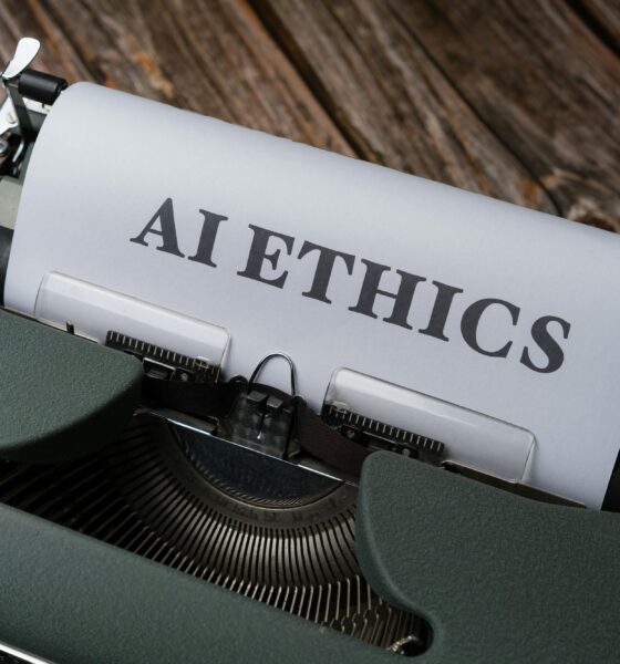 Retro typewriter with 'AI Ethics' on paper, conveying technology themes.